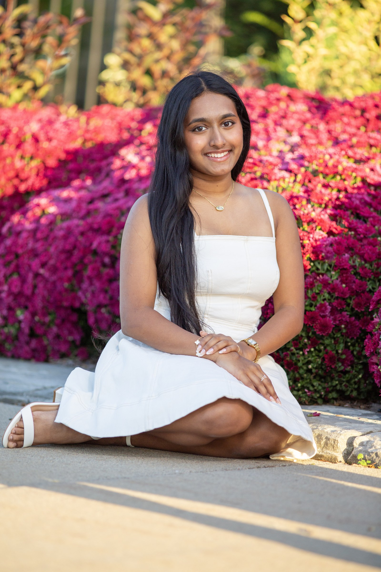 Senior portrait of Niveditha Sunil among flowering trees